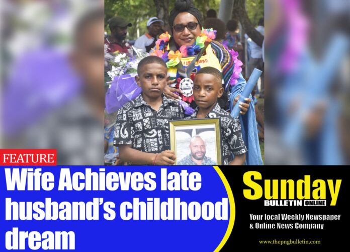 Caption: Mrs Jacinta Garu Makiba and her two children holding late late Amon Makiba's framed photo after the graduation. Caption: Mrs Jacinta Garu Makiba and her two children holding late late Amon Makiba's framed photo after the graduation.