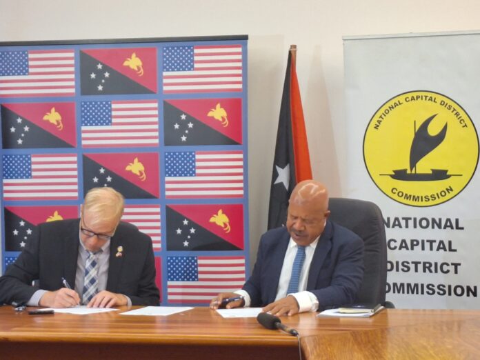 From left to right: Mr Jeff Williams - Director of Community Engagement in the Office of the Mayor of Long Beach and Governor for NCD Powes Parkop signing the MoU of Sister city between NCD and Long Beach. Pic by DALCY LULUA