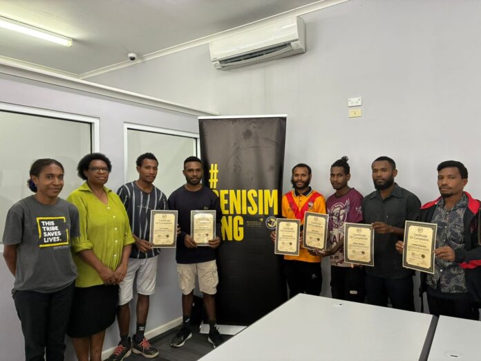 Youths receiving certificates from Senisim PNG Coordinator for Port Moresby Agnes Andrias at PNG Tribal Foundation office in Port Moresby yesterday. Picture supplied.