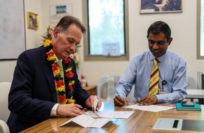 From left, BSP Group general manager, people and culture, Johnathan Harvey and IBSU Vice Chancellor Professor Ramachandran Arunachalam sign the MoU. Picture supplied.