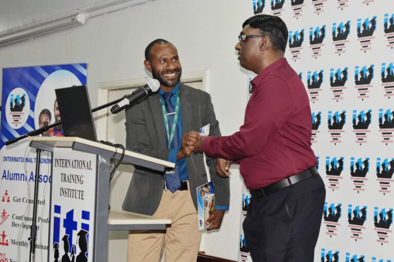 The Chairman and Co-founder of International Training Institute(ITI) Senthil Kumaran Sentheyal(right) officially launching and Presenting the ITI Alumni Membership card to Mr Milton Hompimie Neinguma(left) one of the first two recipients of the ITI Alumni Membership Card during the 2nd Alumni Meeting in Port Moresby Photo supplied by ITI Media