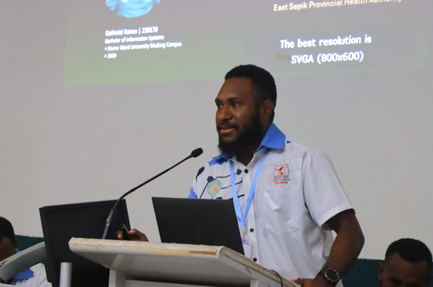 Oathniel Konou, a final-year Information Systems student, presenting his final-year project during the 21st Information Systems Symposium 2026 at Divine Word University, Madang Campus.